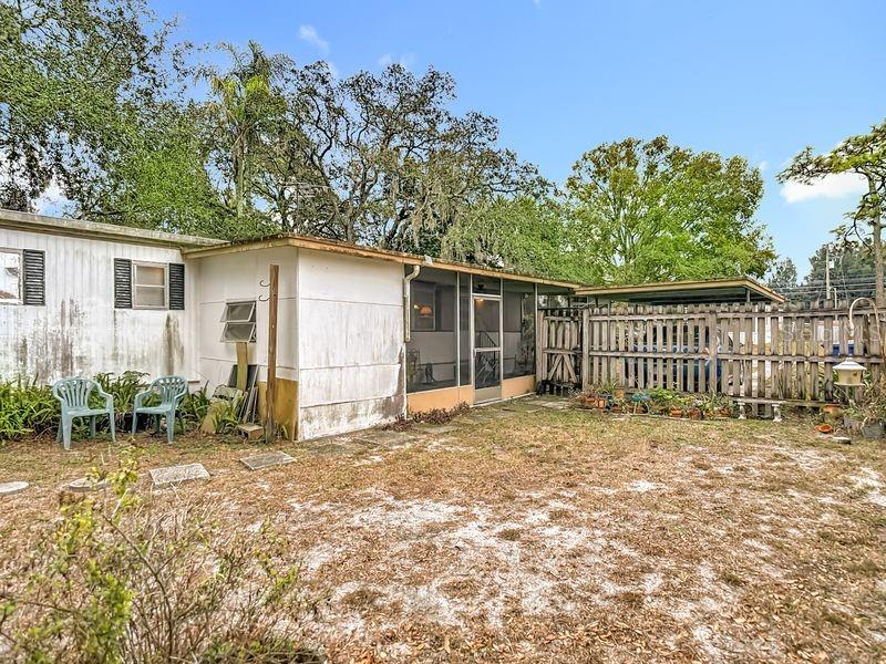8145 Campbell Court New Port Richey, FL 34653 - Photo 27 of 34 a backyard of a house with table and chairs