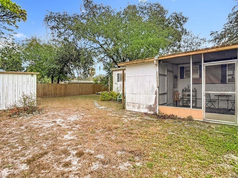 8145 Campbell Court New Port Richey, FL 34653 - Photo 31 of 34 a view of a backyard with a large tree