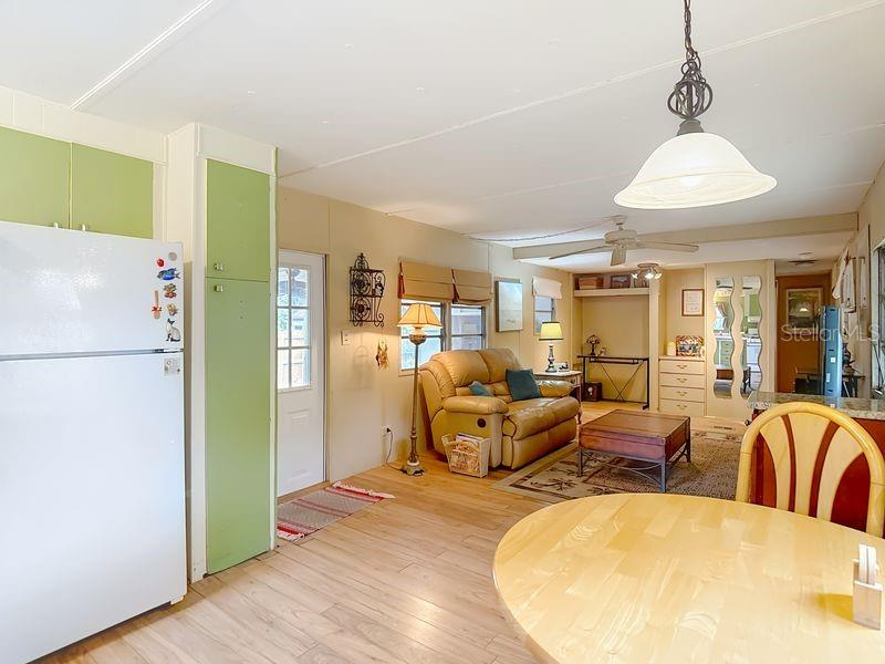 8145 Campbell Court New Port Richey, FL 34653 - Photo 8 of 34 a living room with furniture dining table and a refrigerator