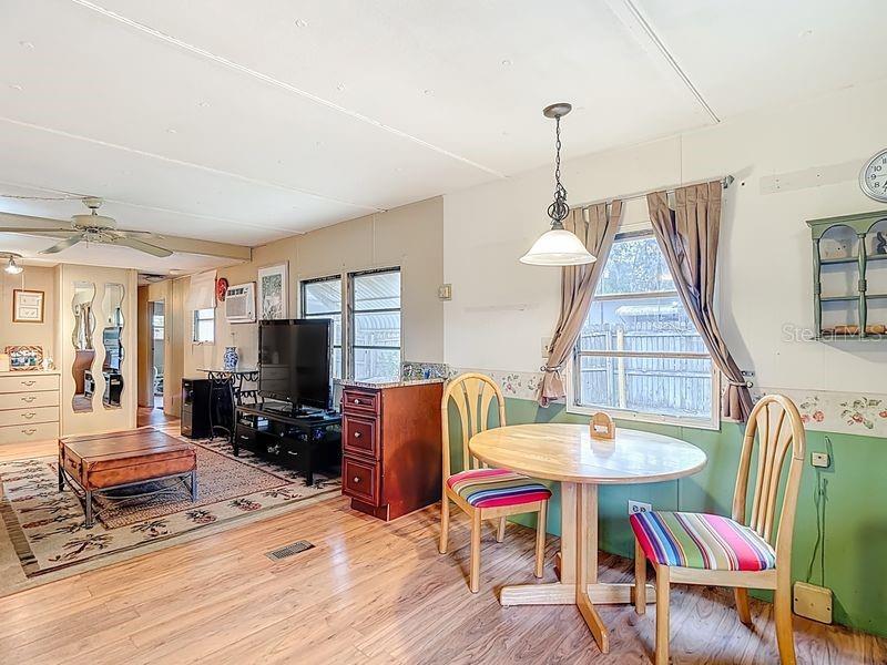 8145 Campbell Court New Port Richey, FL 34653 - Photo 9 of 34 a living room with furniture a dining table and a chandelier