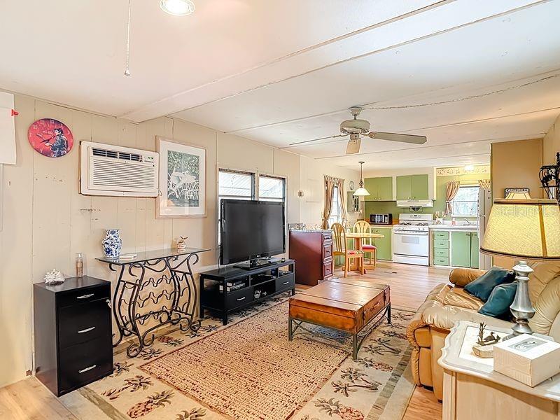 8145 Campbell Court New Port Richey, FL 34653 - Photo 10 of 34 a living room with furniture a rug and a flat screen tv