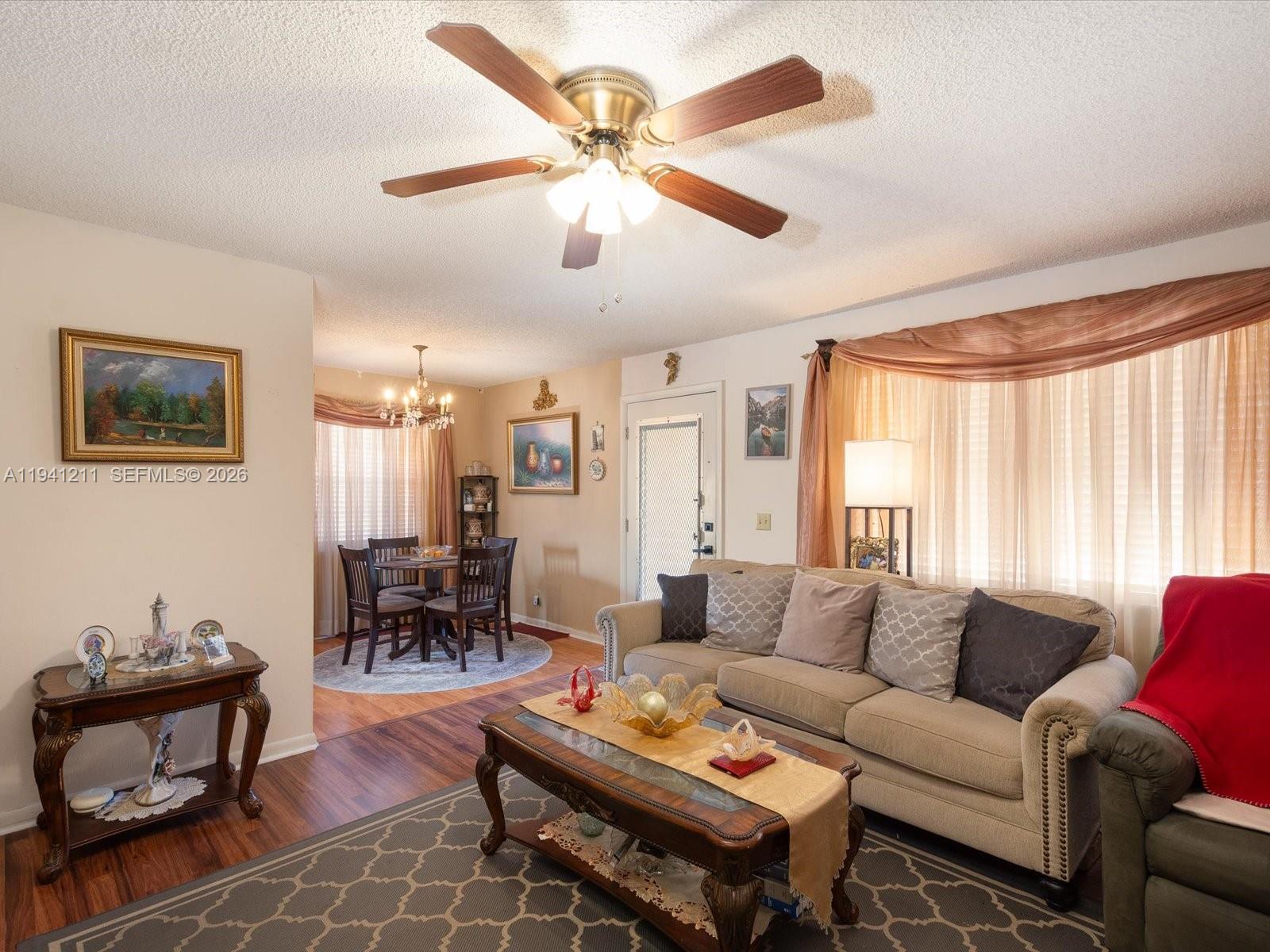 414 Capri H, Unit 414 Delray Beach, FL 33484 - Photo 12 of 19 a living room with furniture a table and a large window