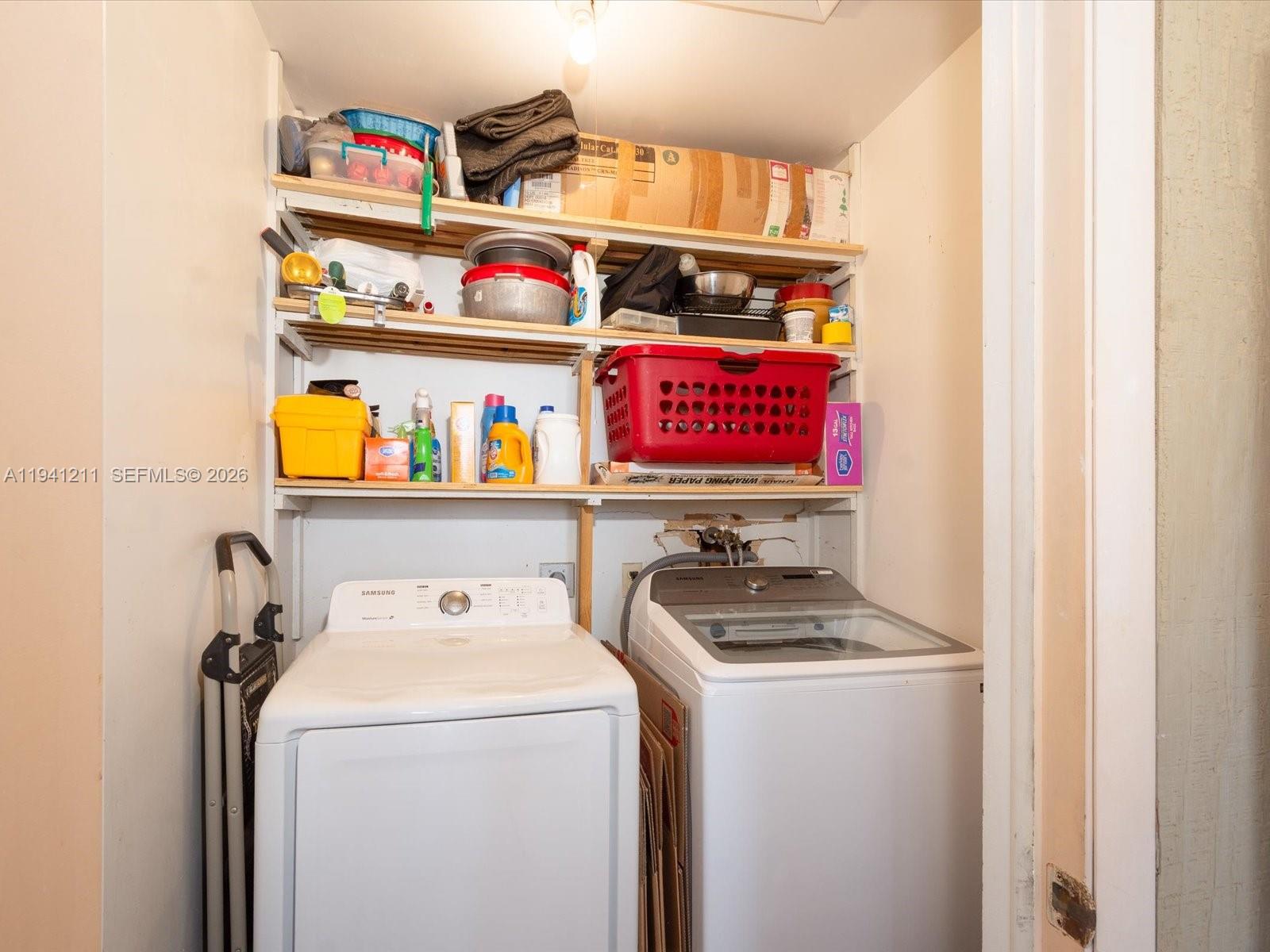 414 Capri H, Unit 414 Delray Beach, FL 33484 - Photo 15 of 19 a utility room with dryer and washer