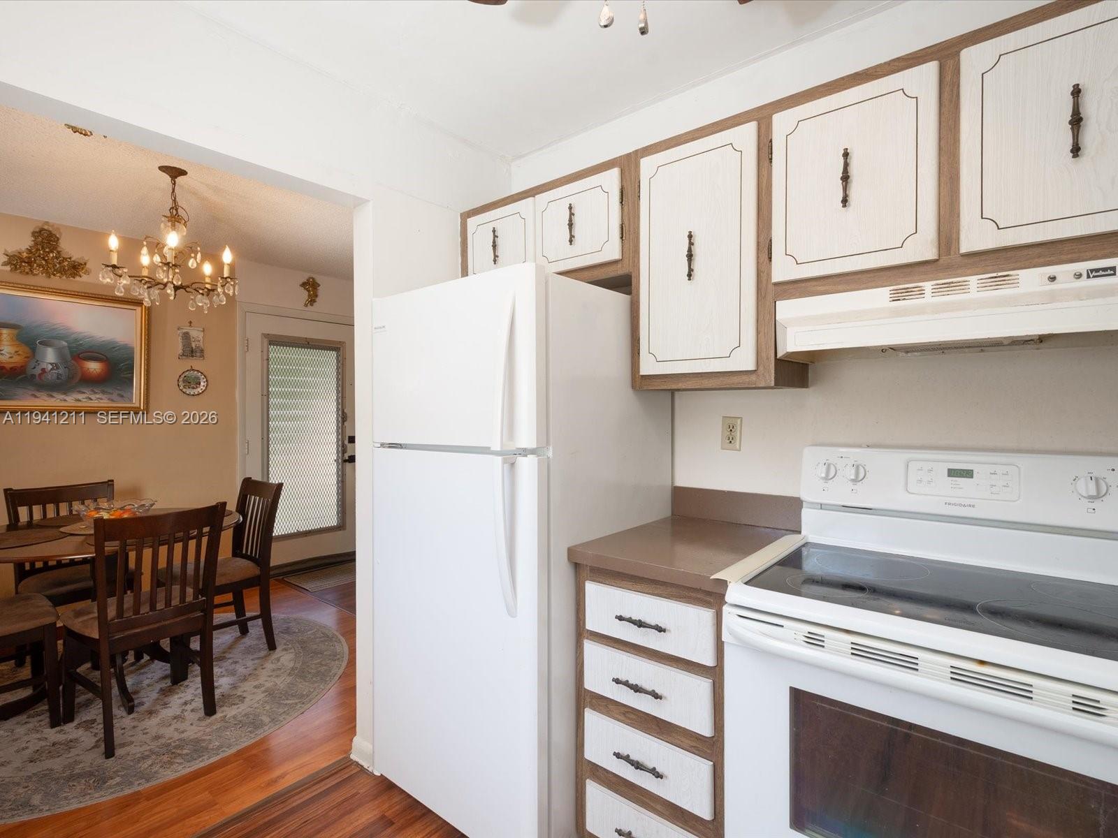 414 Capri H, Unit 414 Delray Beach, FL 33484 - Photo 4 of 19 a kitchen with stainless steel appliances granite countertop a refrigerator and a stove top oven