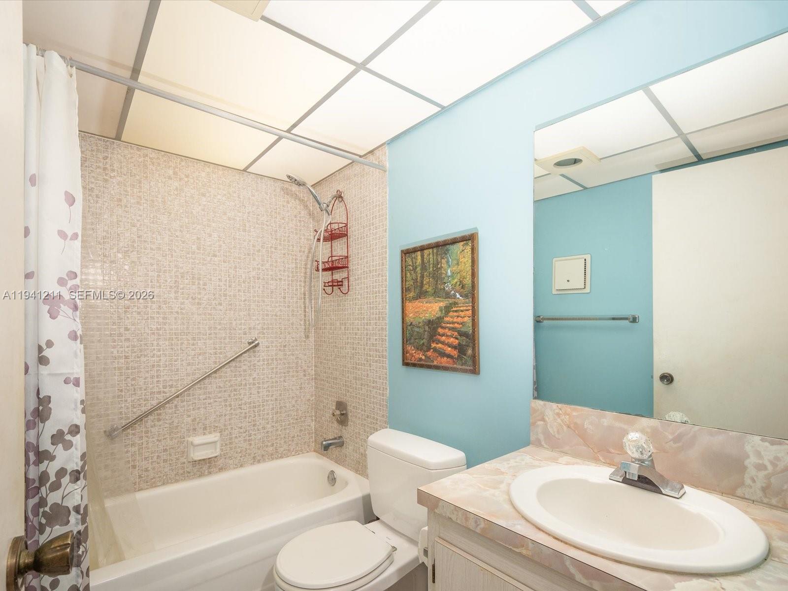414 Capri H, Unit 414 Delray Beach, FL 33484 - Photo 6 of 19 a bathroom with a sink toilet and shower