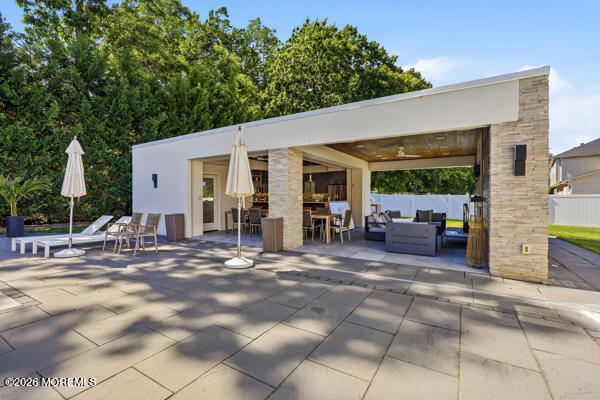 54 Georgetown Road Eatontown, NJ 07724 - Photo 18 of 24 a view of a patio with table and chairs potted plants and a large tree