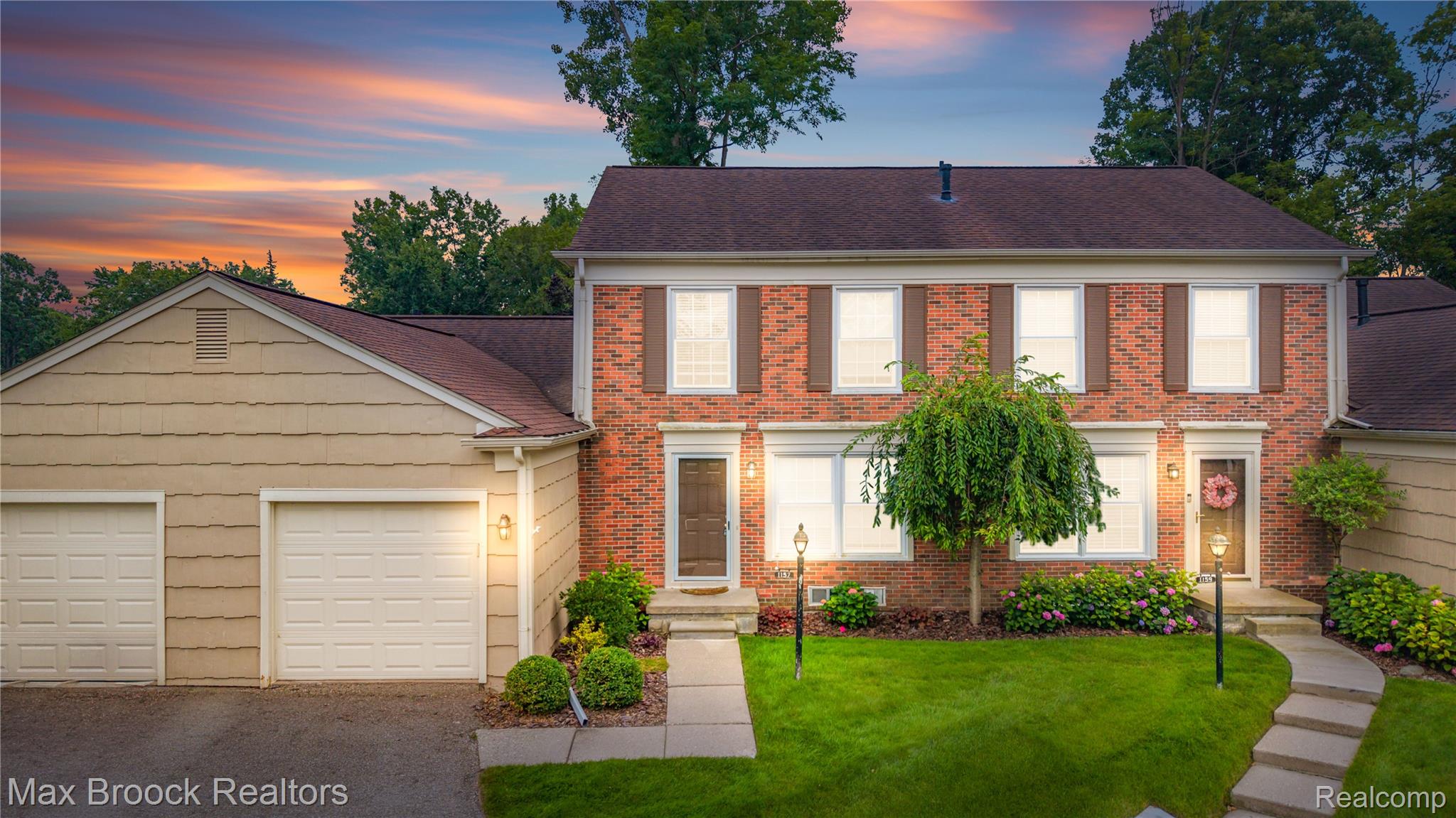 1157 Pine Ridge Court Rochester, MI 48306 - Photo 1 of 55 Brick Colonial with elegant front elevation featuring symmetrical fenestration, white-trimmed windows, and a welcoming entry portico