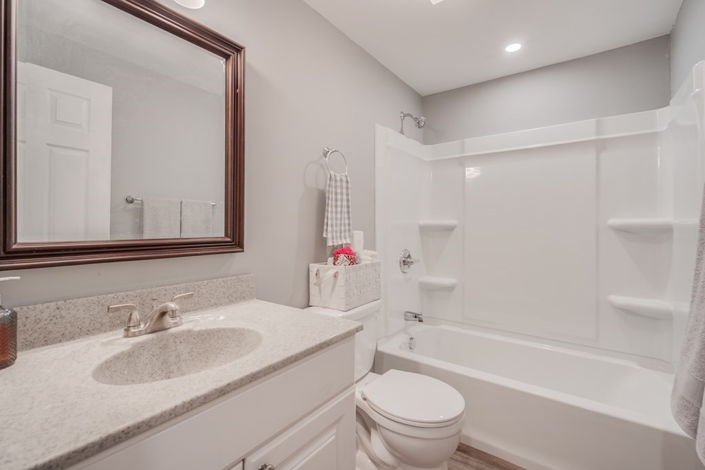 858 Bradley Road Springfield, MA 01109 - Photo 17 of 36 a bathroom with a granite countertop sink toilet mirror vanity and bathtub