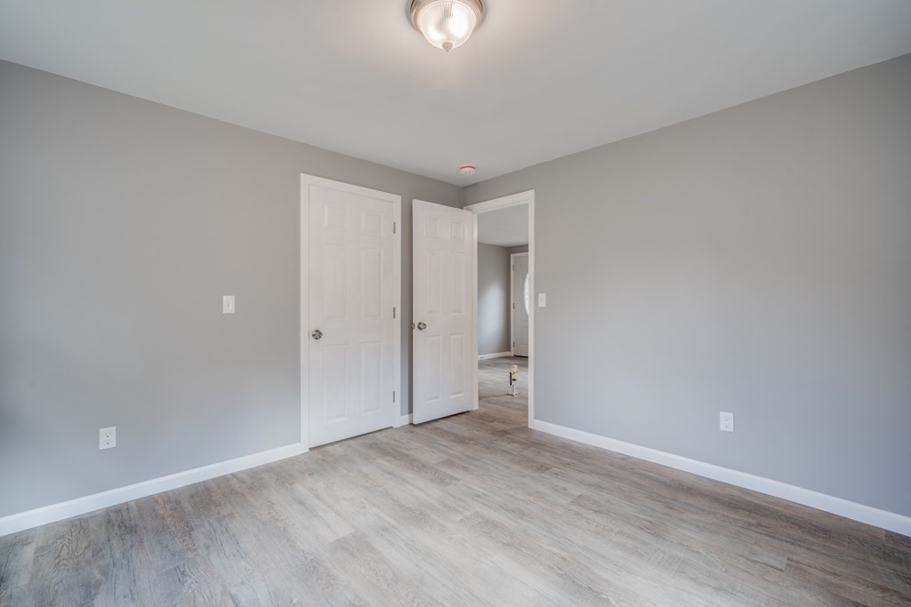 858 Bradley Road Springfield, MA 01109 - Photo 27 of 36 a view of an empty room with wooden floor