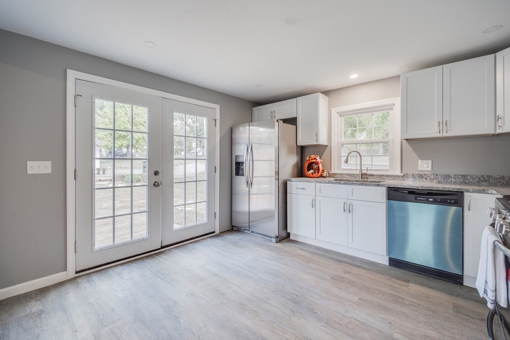 858 Bradley Road Springfield, MA 01109 - Photo 28 of 36 a kitchen with stainless steel appliances granite countertop a refrigerator sink and cabinets