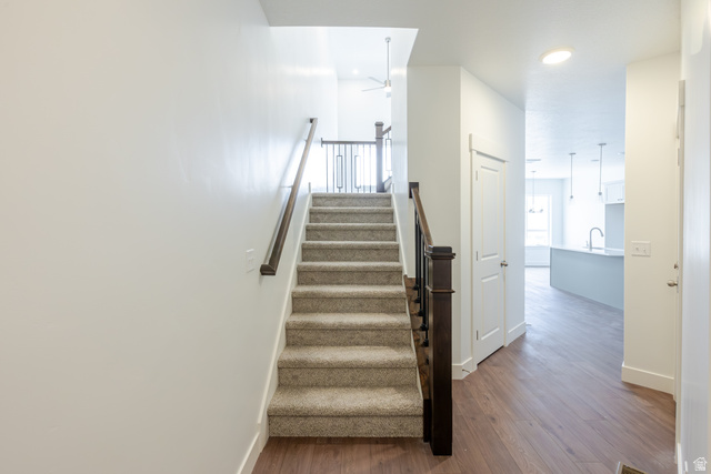 4816 Heartwood Road, Unit 423 Mapleton, UT 84664 - Photo 13 of 21 Stairway featuring wood finished floors, ceiling fan, and recessed lighting