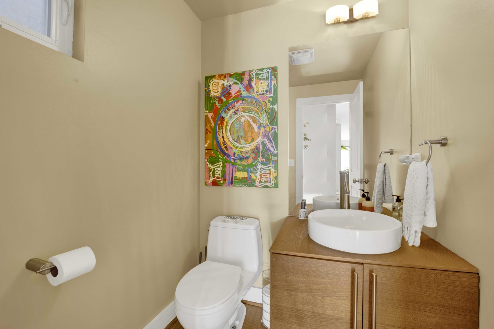 2648 West Homer Street Chicago, IL 60647 - Photo 11 of 49 a bathroom with a sink a toilet a mirror and shower curtain