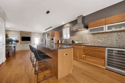 a kitchen with stainless steel appliances sink stove refrigerator and cabinets