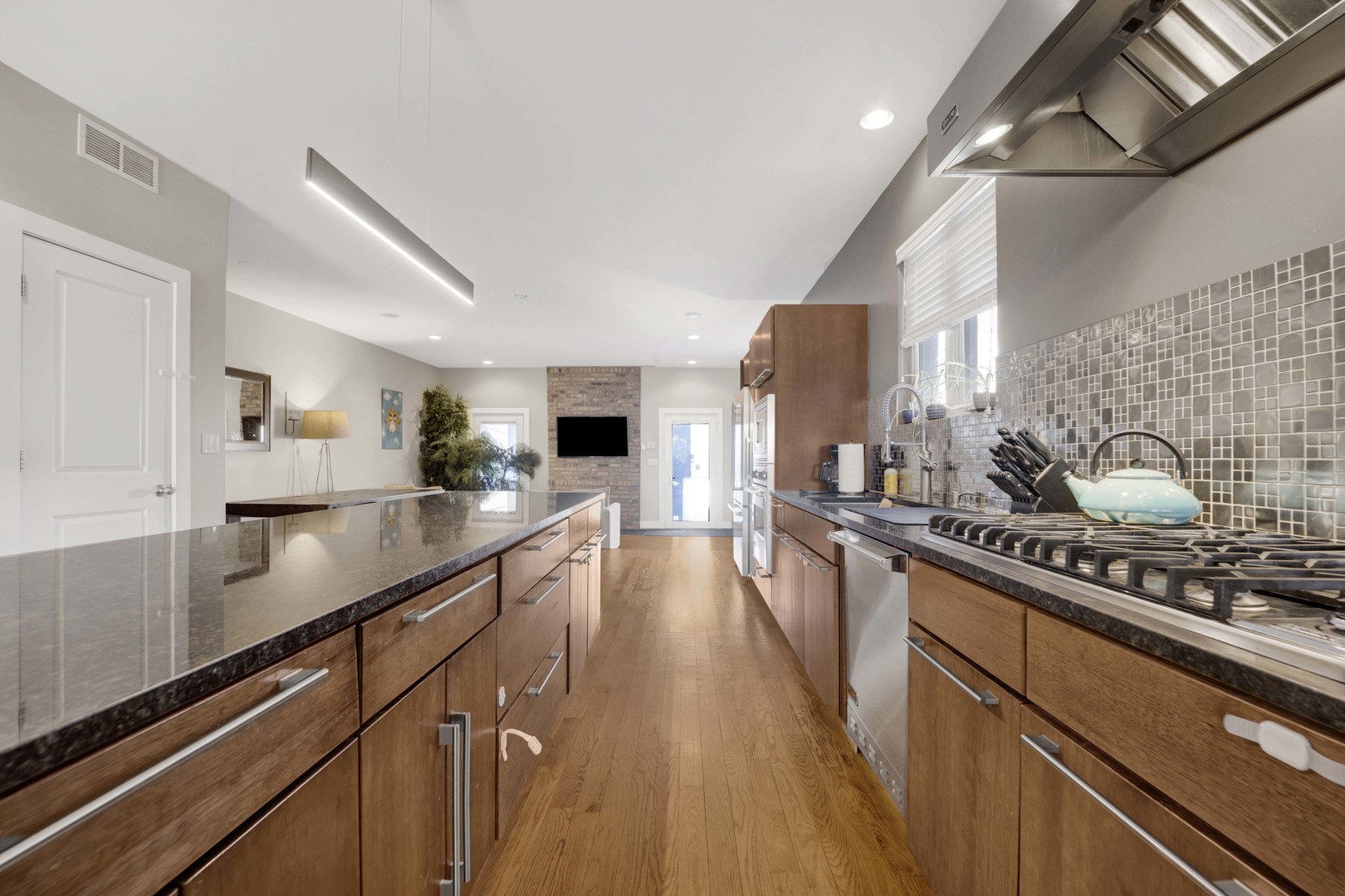 2648 West Homer Street Chicago, IL 60647 - Photo 13 of 49 a kitchen with stainless steel appliances sink stove refrigerator and cabinets