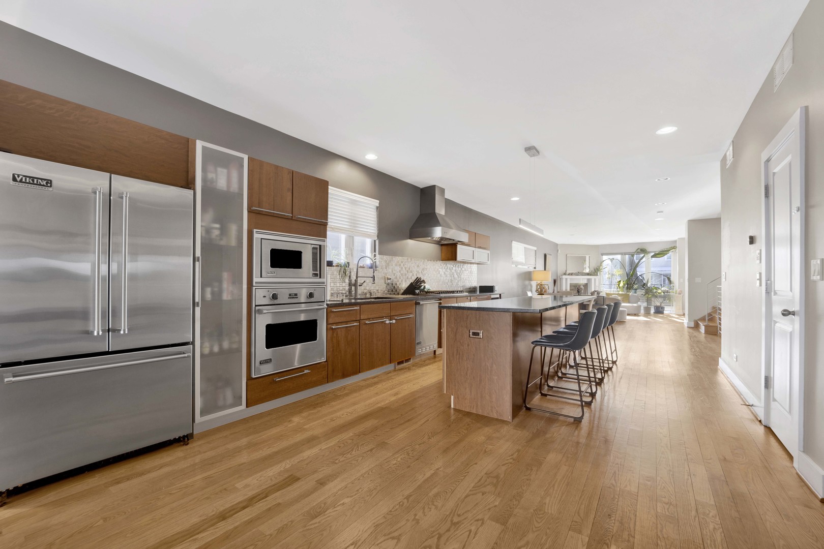 2648 West Homer Street Chicago, IL 60647 - Photo 14 of 49 a kitchen with stainless steel appliances a refrigerator a sink dishwasher a stove and a microwave oven with wooden floor