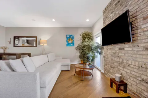 a living room with furniture and a potted plant