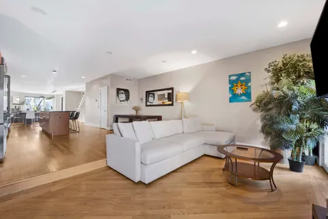 a living room with furniture flat screen tv and a couch