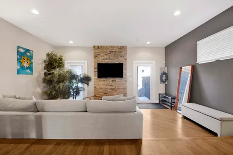 a bedroom with furniture and wooden floor