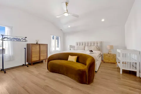 a spacious bedroom with a bed and a couch