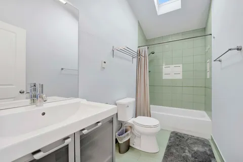 a bedroom with a bed and a night stand