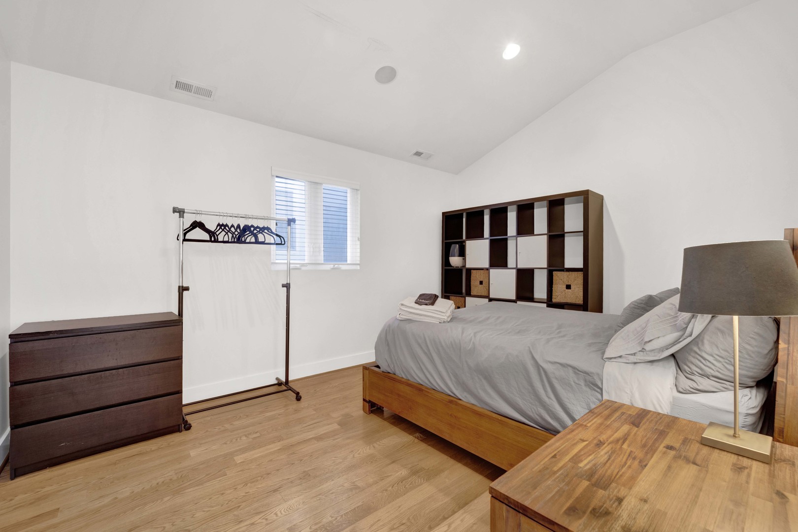 2648 West Homer Street Chicago, IL 60647 - Photo 34 of 49 a bedroom with a bed and a lamp with the dresser