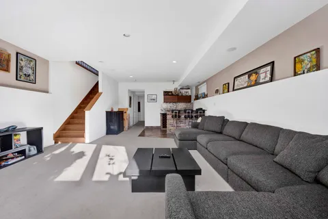 a kitchen with granite countertop a stove and white cabinets
