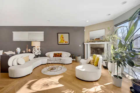 a living room with fireplace furniture and a window