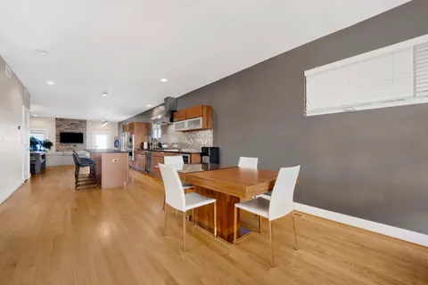 a dining room with furniture and wooden floor