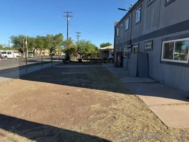 a view of a house with a yard and potted plants