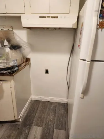 a view of a room with wooden floor