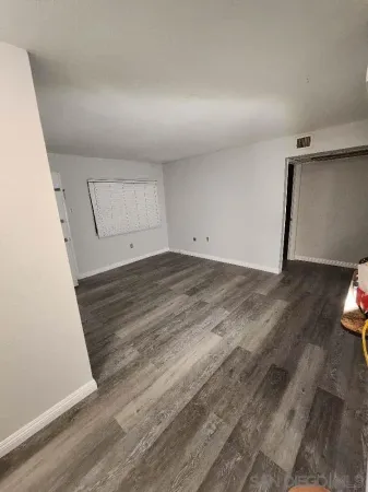 a view of a room with wooden floor