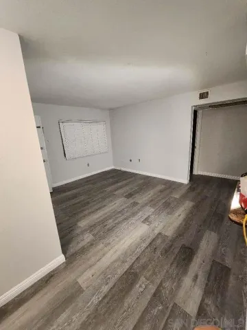 a view of a room with wooden floor