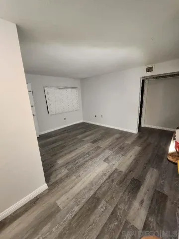 a view of kitchen with stove and refrigerator