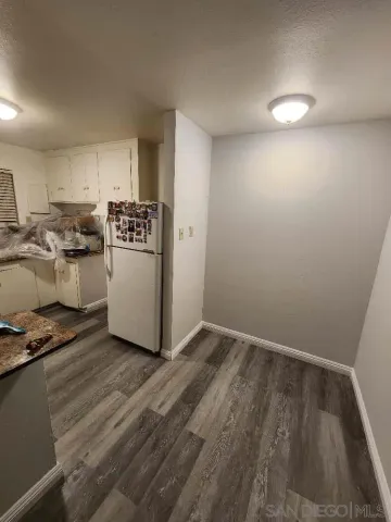 a view of a livingroom with wooden floor and a flat screen tv