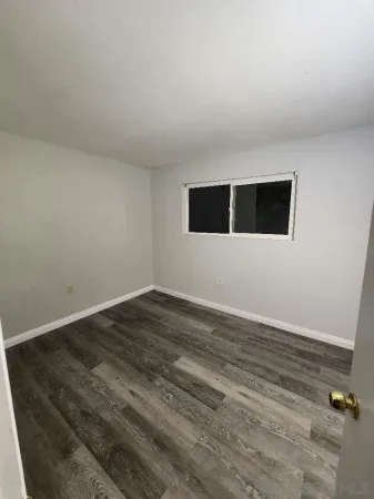 an empty room with wooden floor