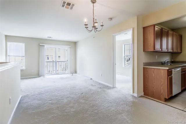 a view of a kitchen with refrigerator and cabinets