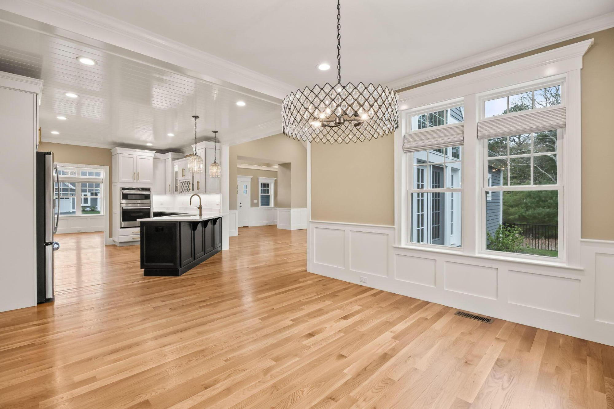 a view of a kitchen with stainless steel appliances granite countertop a oven a stove and a wooden floors