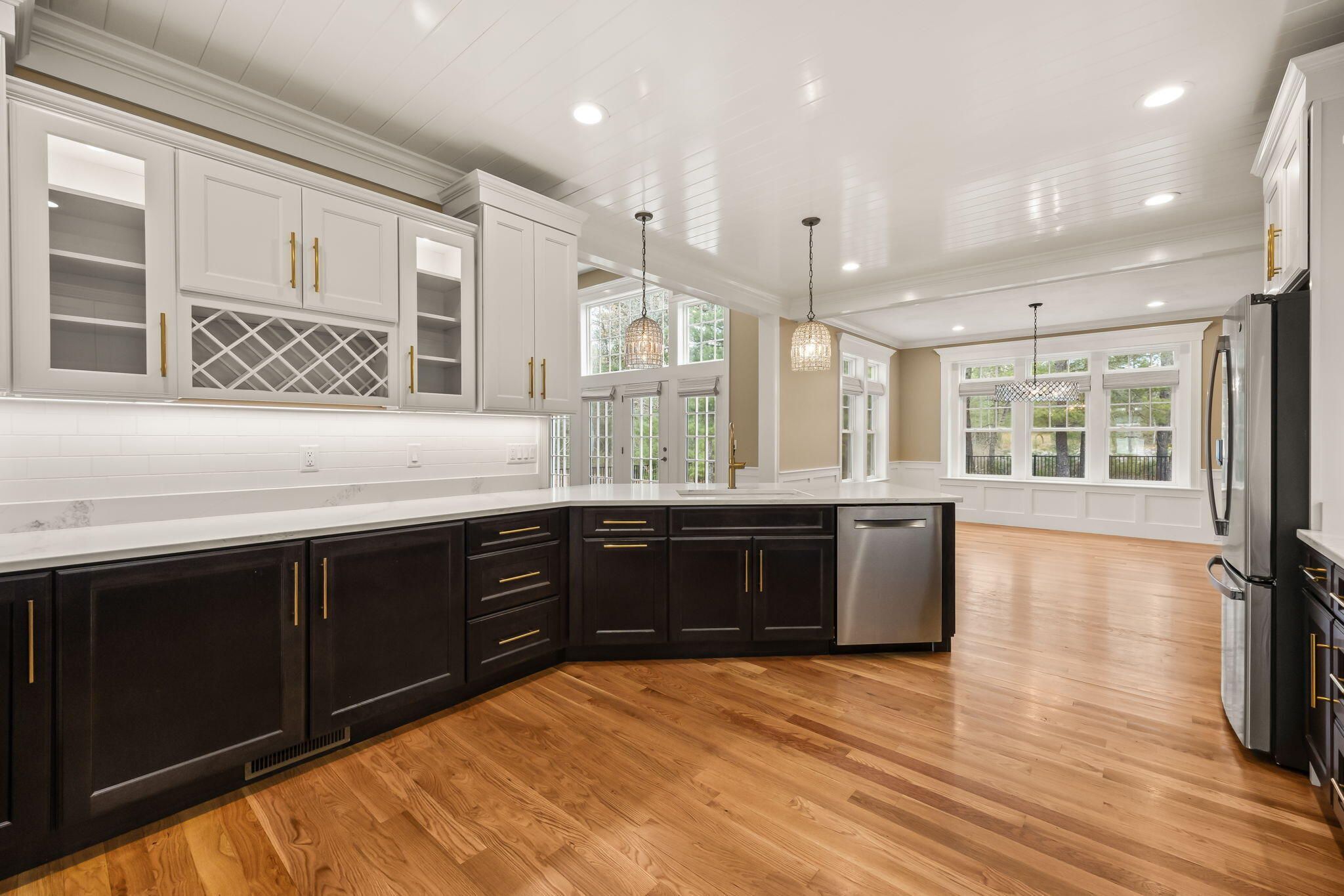 7 Nicklaus Way Mashpee, MA 02649 - Photo 14 of 45 a large kitchen with stainless steel appliances granite countertop a sink dishwasher stove and wooden cabinets