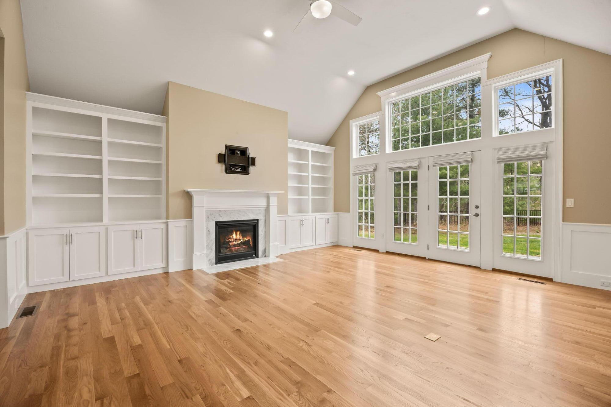 7 Nicklaus Way Mashpee, MA 02649 - Photo 6 of 45 a view of an empty room with a fireplace and a window