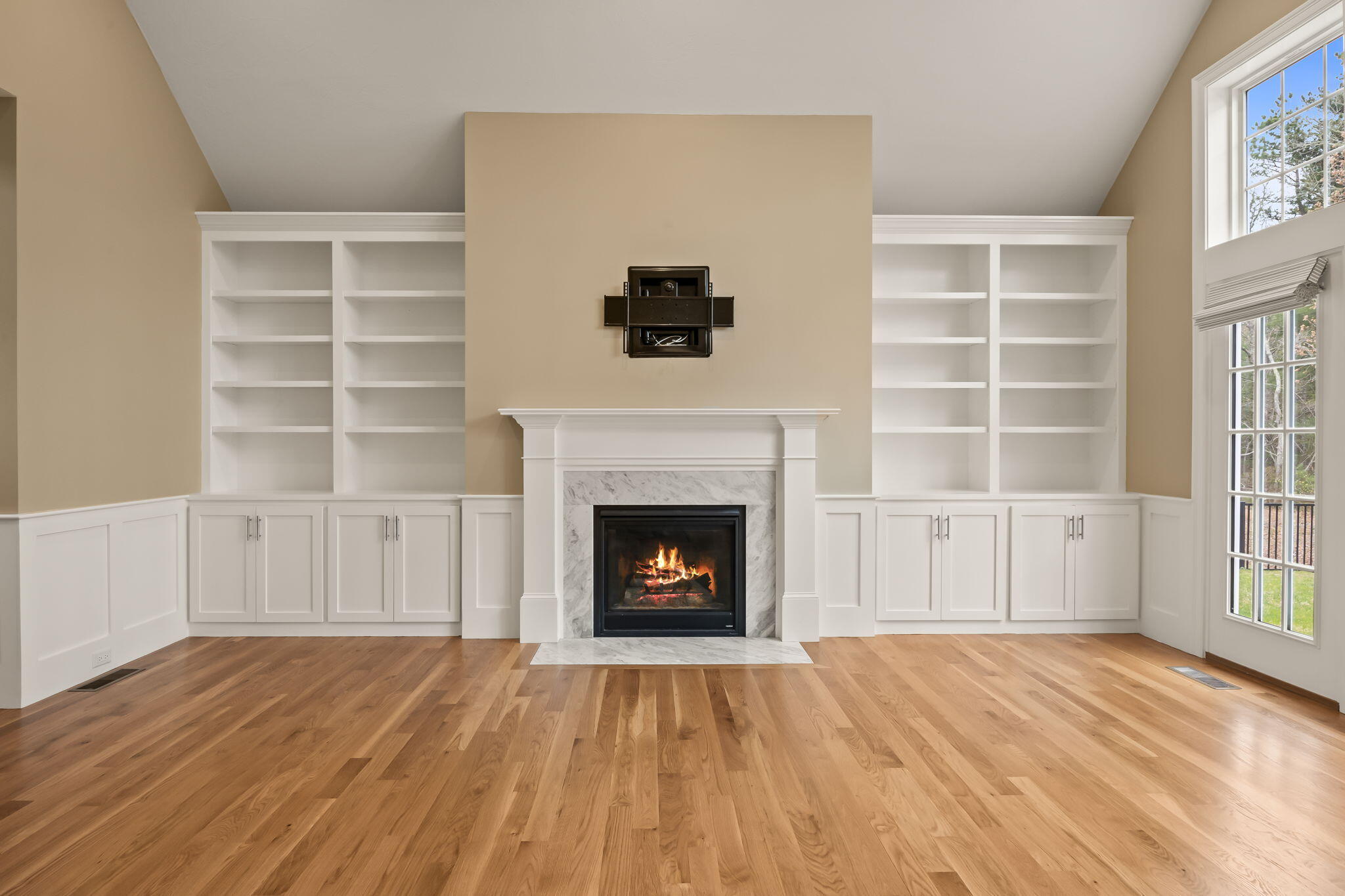 7 Nicklaus Way Mashpee, MA 02649 - Photo 7 of 45 a living room with a fireplace and a window