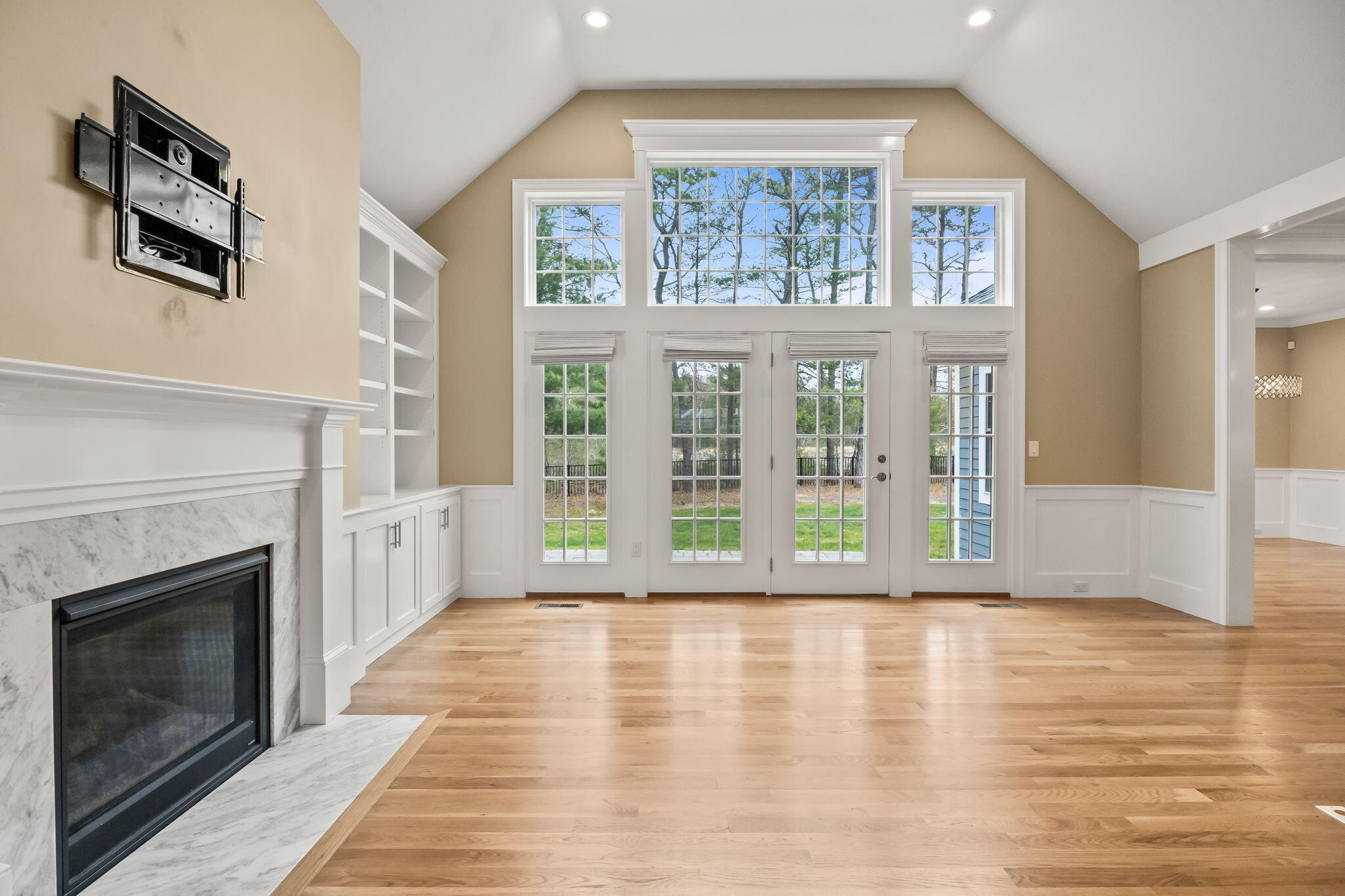 7 Nicklaus Way Mashpee, MA 02649 - Photo 8 of 45 a view of an empty room with wooden floor and a fireplace