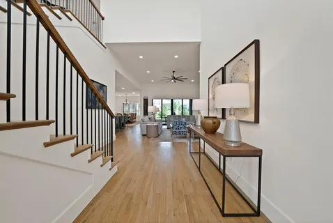 a view of entryway and hall with wooden floor
