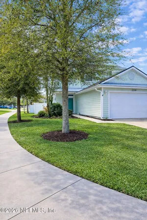 a front view of house with yard and green space