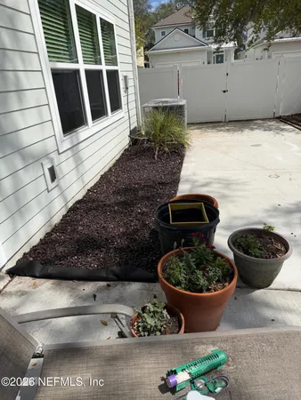 a view of a backyard of the house with potted plants