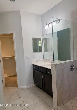 a bathroom with a double vanity sink and mirror