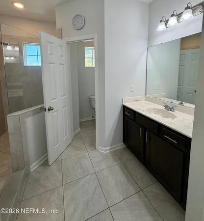 a bathroom with a sink a toilet and mirror