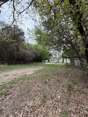 a big yard with lots of green space and trees