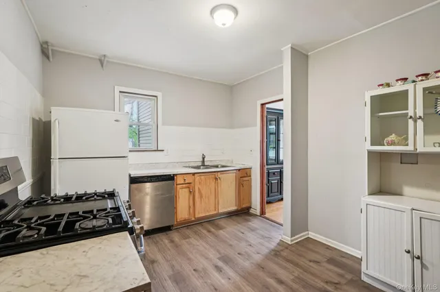 a kitchen with a refrigerator and a stove top oven