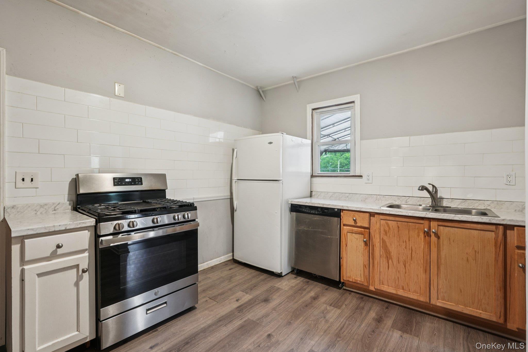 334 Union Avenue Peekskill, NY 10566 - Photo 7 of 20 a kitchen with granite countertop white cabinets and white appliances