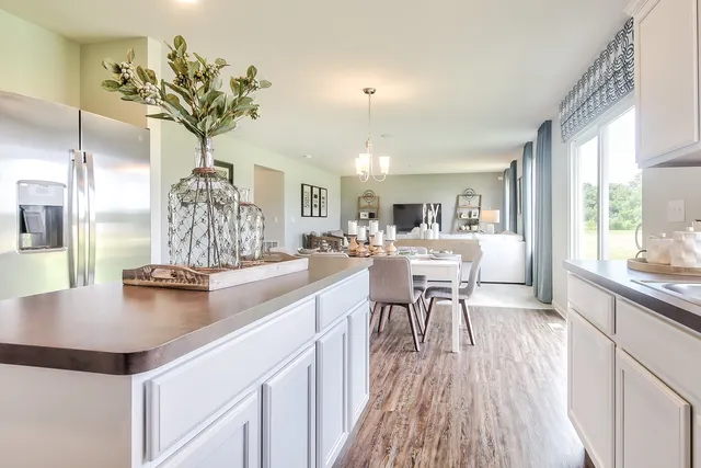 a kitchen with a table and chairs